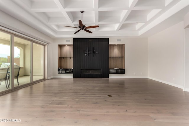 unfurnished living room with wood finished floors, a ceiling fan, baseboards, and coffered ceiling