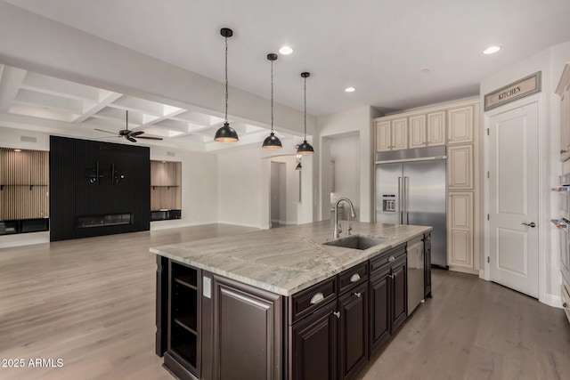 kitchen with recessed lighting, a ceiling fan, a sink, a kitchen island with sink, and appliances with stainless steel finishes