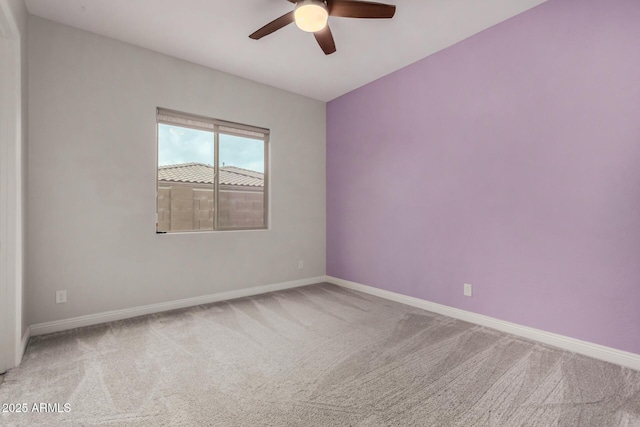 carpeted empty room with baseboards and ceiling fan