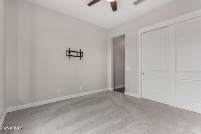unfurnished bedroom featuring visible vents, a ceiling fan, carpet floors, a closet, and baseboards