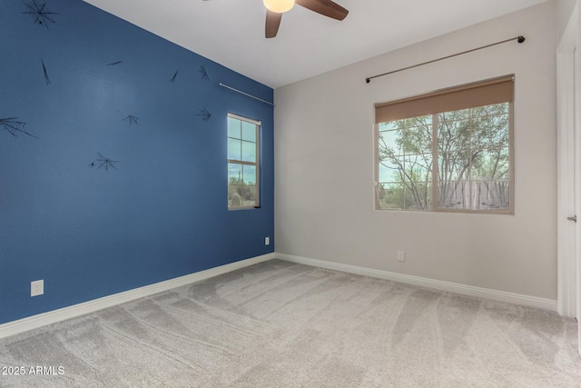 unfurnished room with carpet, a healthy amount of sunlight, baseboards, and ceiling fan