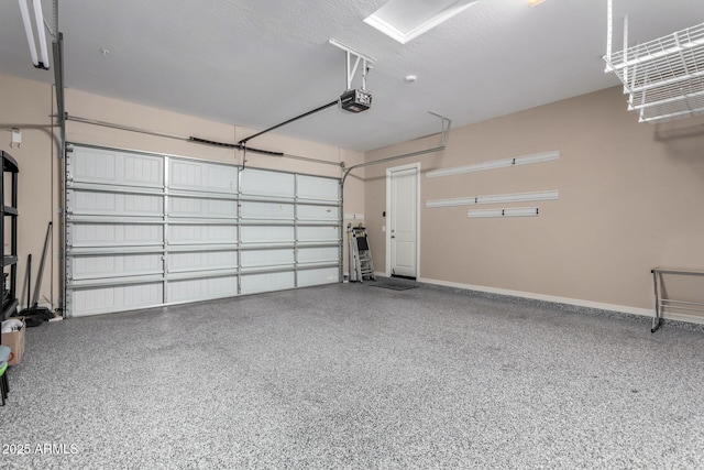 garage featuring a garage door opener and baseboards