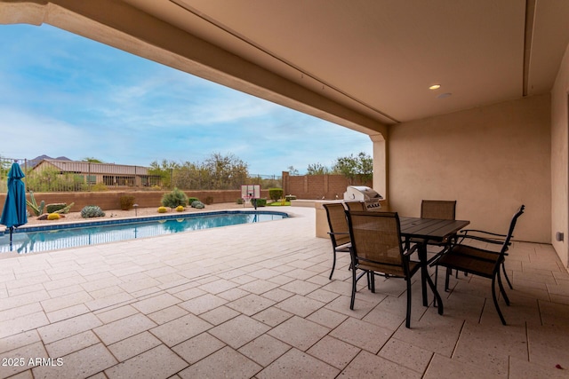 view of swimming pool with a fenced in pool, a fenced backyard, a patio area, outdoor dining space, and area for grilling