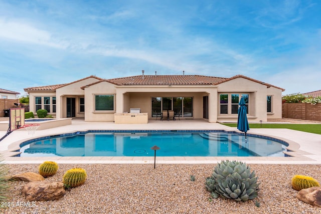 view of swimming pool with a fenced in pool, a patio area, fence, and a jacuzzi