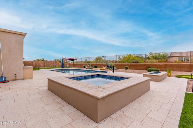 view of pool with a fire pit, a fenced backyard, a patio, and an in ground hot tub