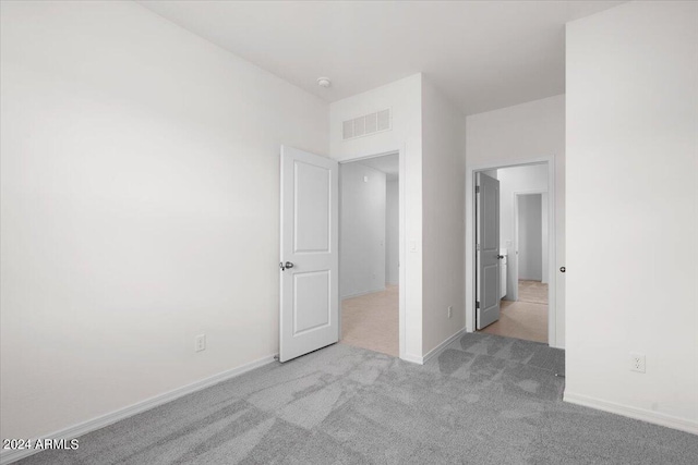 unfurnished bedroom with light colored carpet