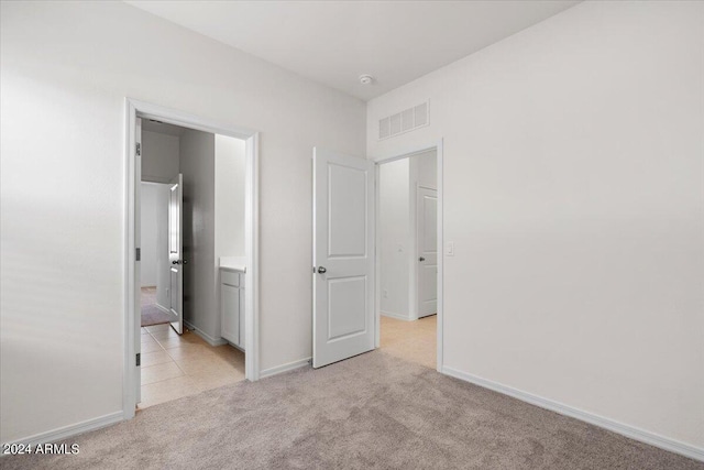 unfurnished bedroom featuring light colored carpet