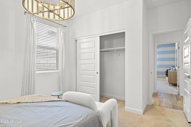 bedroom featuring carpet, baseboards, and a closet