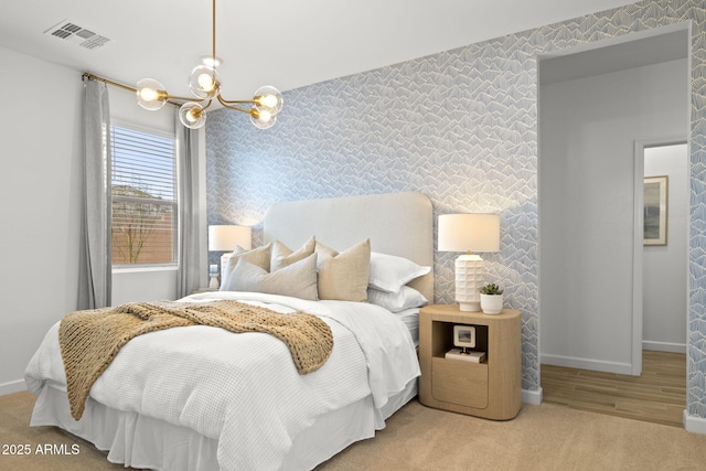 carpeted bedroom featuring baseboards, visible vents, and wallpapered walls