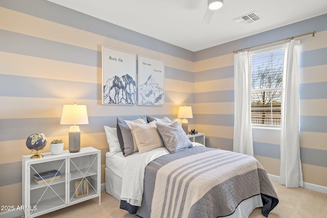 carpeted bedroom with baseboards, visible vents, and ceiling fan