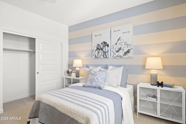 carpeted bedroom featuring a closet and baseboards