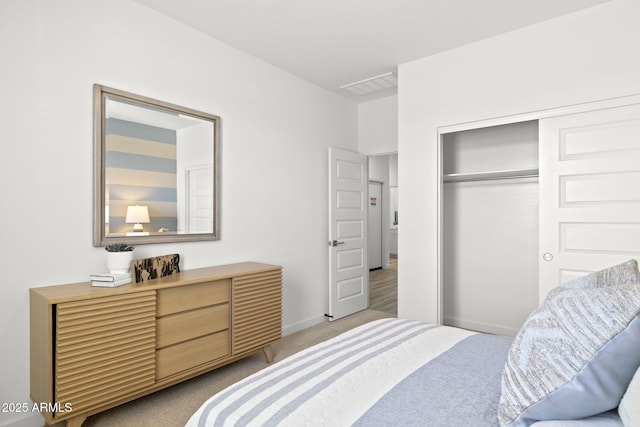 carpeted bedroom featuring a closet, visible vents, and baseboards