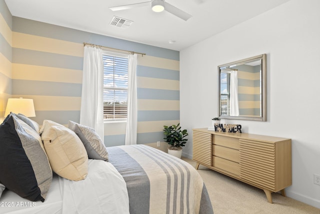 bedroom featuring light colored carpet, ceiling fan, visible vents, and baseboards