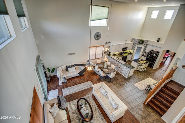 living room featuring tile patterned flooring and a high ceiling