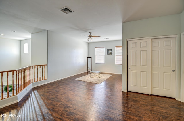 spare room featuring ceiling fan, a healthy amount of sunlight, and dark hardwood / wood-style floors