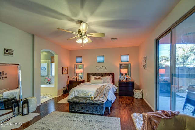 bedroom with access to exterior, dark hardwood / wood-style floors, ceiling fan, and connected bathroom