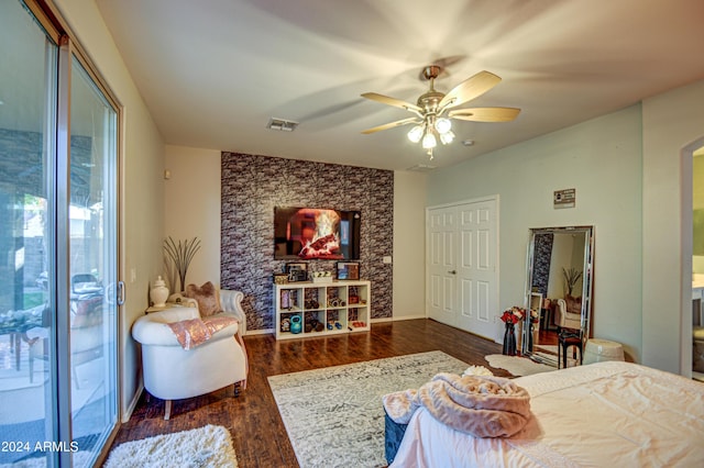 bedroom featuring dark hardwood / wood-style flooring, ceiling fan, and access to outside