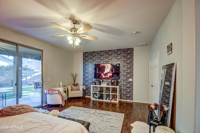 bedroom with dark hardwood / wood-style flooring, ceiling fan, and access to outside