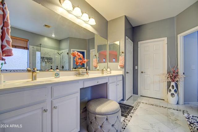 bathroom with a shower with door and vanity