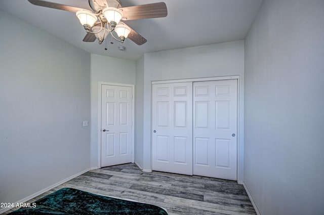 unfurnished bedroom featuring a closet, ceiling fan, and hardwood / wood-style floors