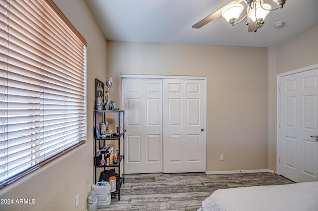 bedroom with ceiling fan, hardwood / wood-style flooring, and a closet