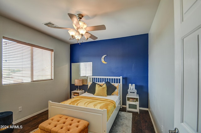 bedroom featuring ceiling fan and dark hardwood / wood-style floors