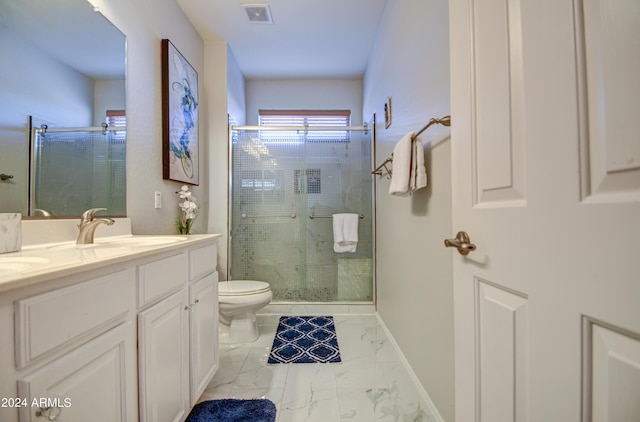 bathroom with toilet, a shower with shower door, and vanity