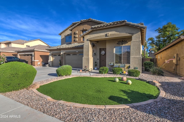 mediterranean / spanish-style home featuring a garage and a front lawn