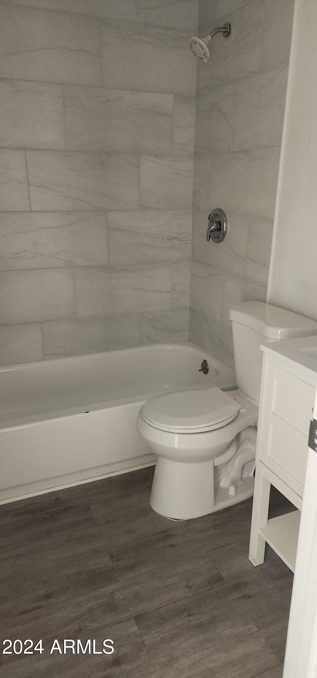 bathroom featuring toilet, vanity, and hardwood / wood-style floors