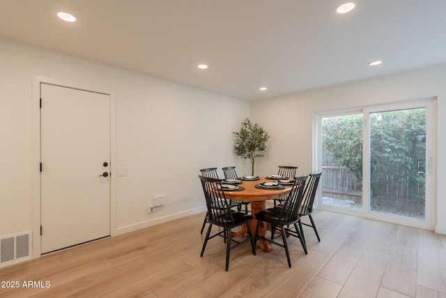 dining room featuring light wood-style floors, recessed lighting, and baseboards