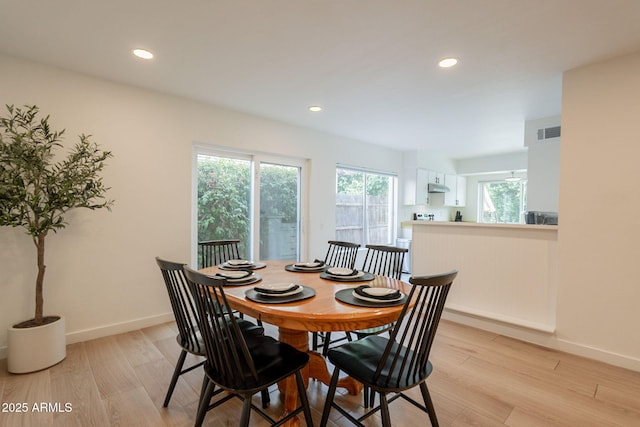 dining space with baseboards, light wood-style flooring, and recessed lighting