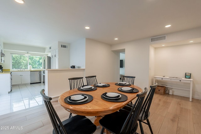 dining space featuring recessed lighting and light wood-style flooring