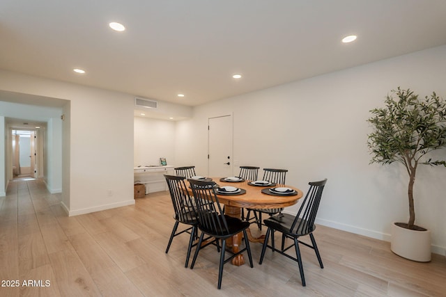 dining space featuring light wood-style flooring, recessed lighting, and baseboards