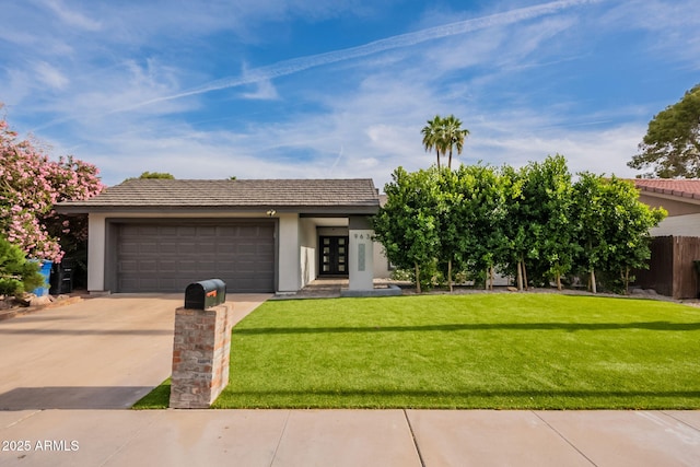 view of front of house with french doors, driveway, a front yard, and stucco siding