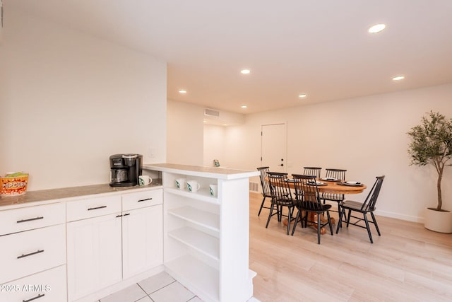 dining room with recessed lighting, light wood finished floors, and baseboards