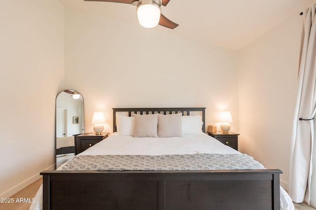bedroom featuring light wood-style flooring, baseboards, and a ceiling fan