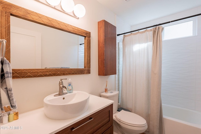 bathroom featuring toilet, shower / tub combo, and vanity