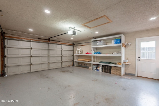 garage featuring a garage door opener and recessed lighting