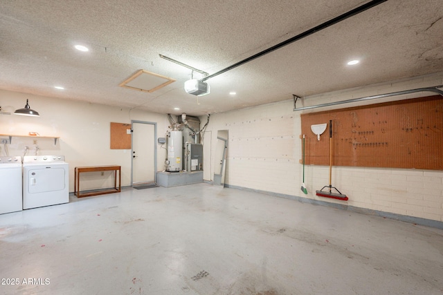 garage featuring washing machine and dryer, a garage door opener, recessed lighting, and gas water heater
