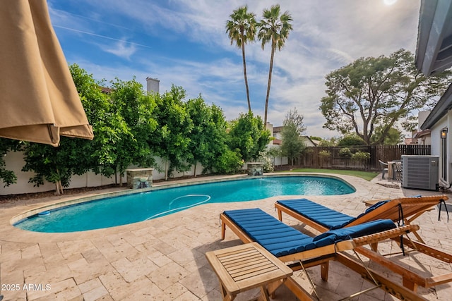 view of pool featuring central air condition unit, a patio, and a fenced backyard