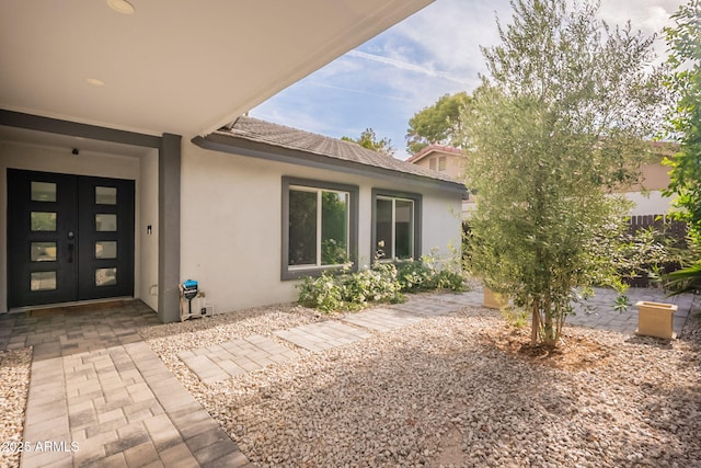 doorway to property with stucco siding and french doors
