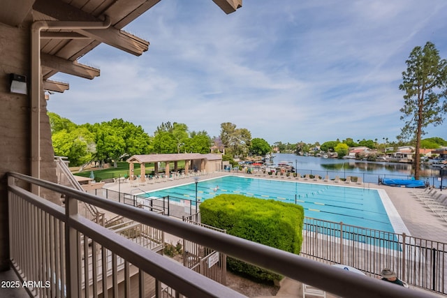 community pool featuring a water view and a patio
