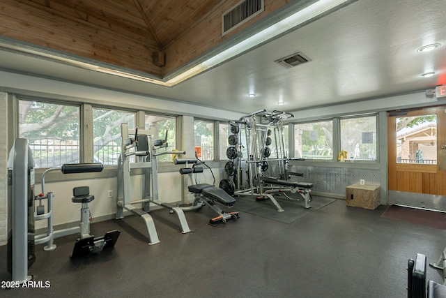 exercise room with healthy amount of natural light, lofted ceiling, and wooden ceiling