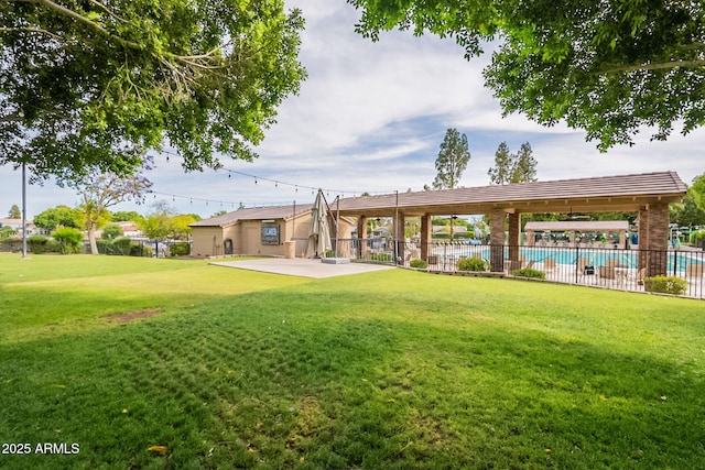 view of yard with a community pool and a patio