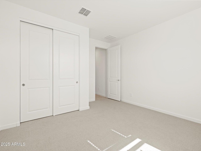 16081 W Remuda Dr, Surprise, AZ 85387 - unfurnished bedroom with baseboards, visible vents, carpet, and a closet
