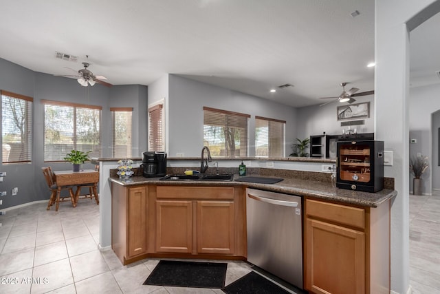 kitchen with a wealth of natural light, visible vents, dishwasher, and a sink