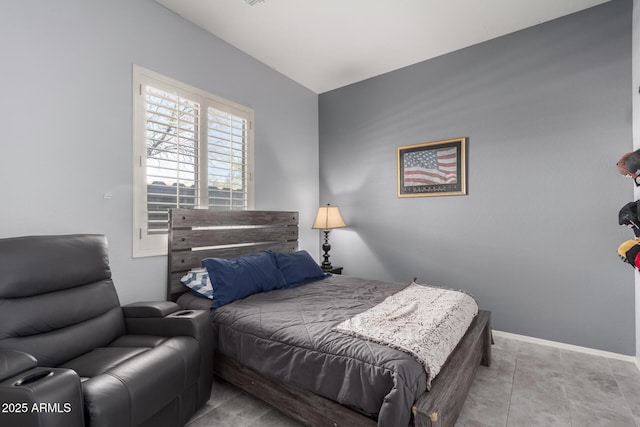 bedroom featuring baseboards and light tile patterned floors