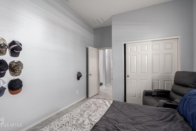 bedroom with a closet, visible vents, and baseboards