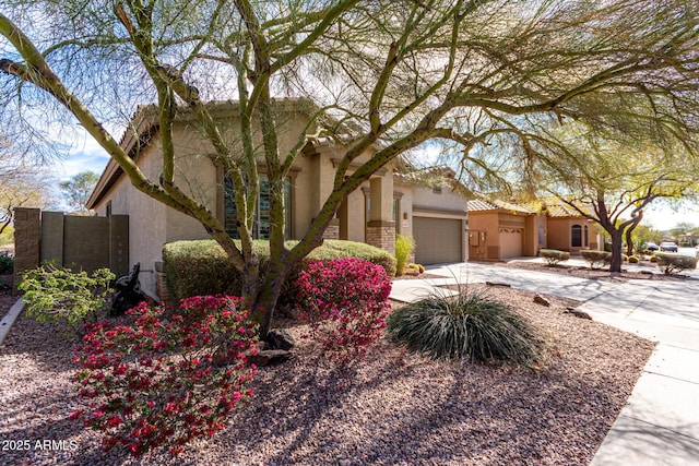 view of front facade featuring driveway, an attached garage, and stucco siding