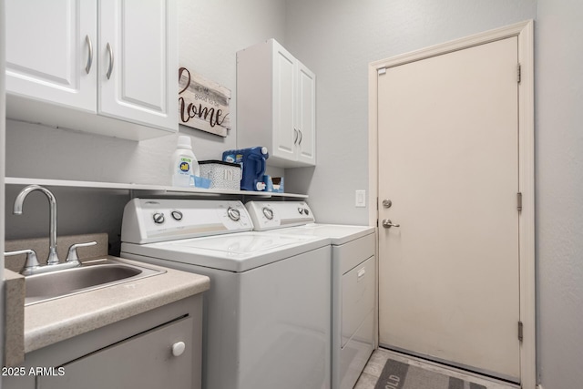 laundry room featuring separate washer and dryer, a sink, and cabinet space